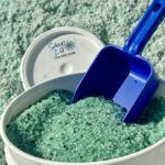 Premium Blend Ice Melt in a 5-gallon bucket, featuring green crystals for effective ice meltin