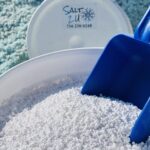 5-gallon bucket of Calcium Chloride Blend Melt, featuring round pellets designed to melt snow and ice quickly, even in extreme cold down to -20°F